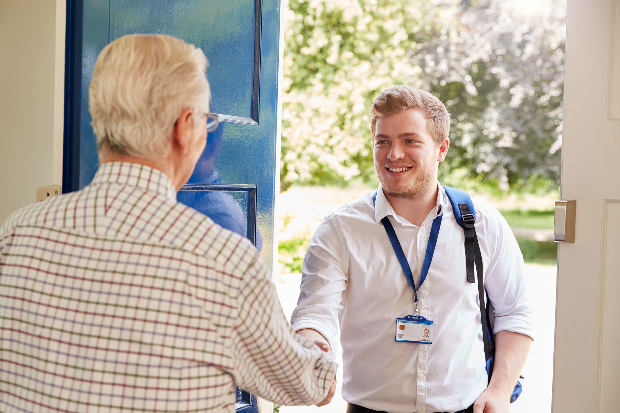 Senior Man Greeting Male Care Worker
